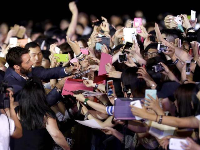 Actor Hugh Jackman signs autographs for his fans during the premiere event of his new film 'The Wolverine' in Seoul, South Korea. (AP Photo)