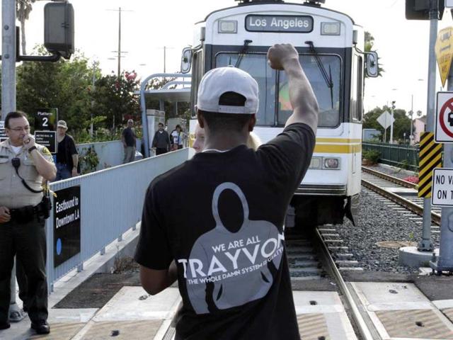 A demonstrator blocks a commuter train as they protest against the acquittal of George Zimmerman in the Trayvon Martin trial, in Los Angeles. (Reuters Photo)