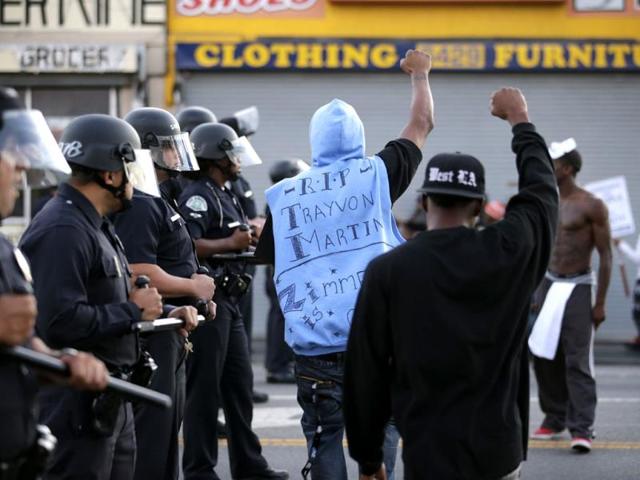 Protesters confront Los Angles police officers during a demonstration in reaction to the acquittal of neighborhood watch volunteer George Zimmerman on Monday, in Los Angeles. (AP Photo)
