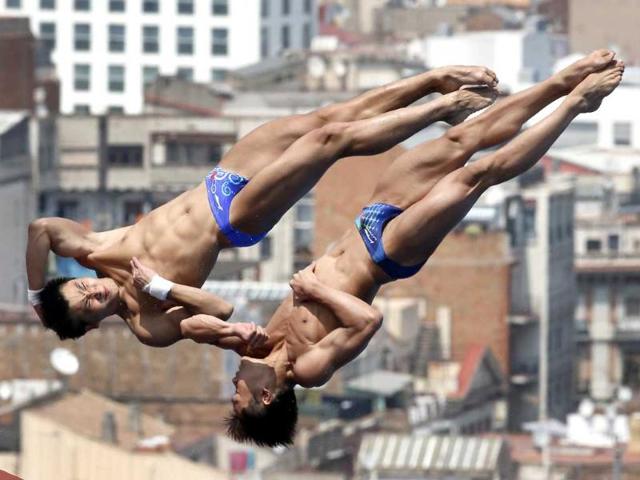 China's Yuan Cao and Yanquan Zhang perform during a 10-meter platform diving training session ahead of the FINA Swimming World Championships in Barcelona, Spain. AP Photo