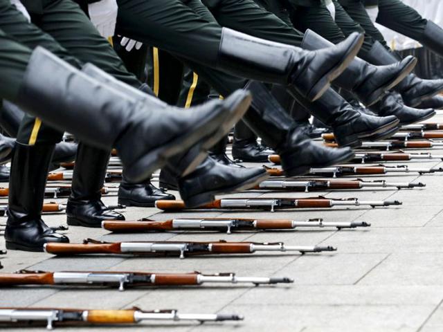 Rifles are laid on the ground as members of an honour guard prepare for a welcoming ceremony for visiting Venezuelan Vice President Jorge Arreaza outside the Great Hall of the People in Beijing, July 18, 2013. REUTERS
