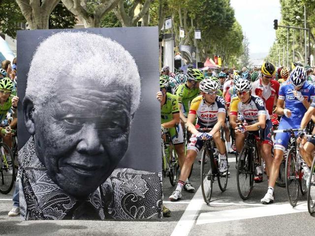 A portrait of Nelson Mandela is displayed in front of cyclists to celebrate the birthday of former South African president Nelson Mandela in Gap, before the start of the 172.5 km eighteenth stage of the 100th edition of the Tour de France cycling race. AFP photo