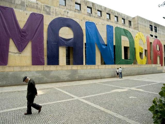 An man walks past a banner with the name of former South African president Nelson Mandela in Matosinhos City Hall, Matosinhos, Portugal. AP Photo