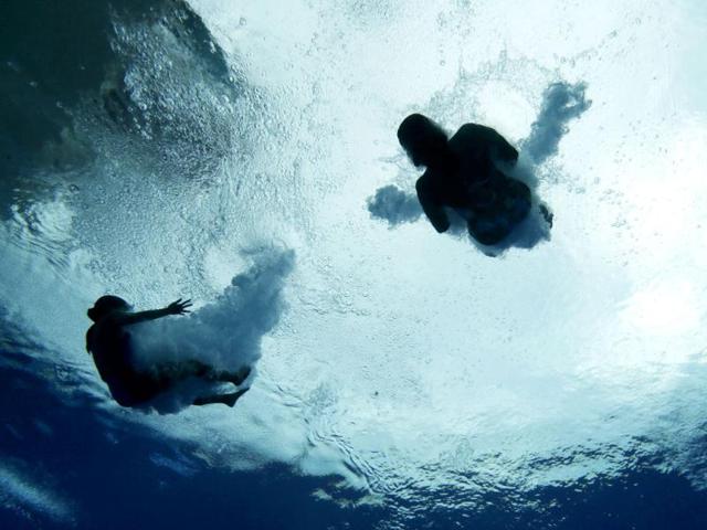 Divers train on the 3-meter springboard at the FINA Swimming World Championships in Barcelona, Spain. (AP Photo)
