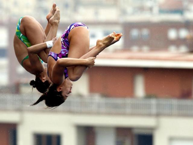 Two unidentified 10-meter platform diver's perform during a training session ahead of the FINA Swimming World Championships in Barcelona, Spain. (AP Photo)