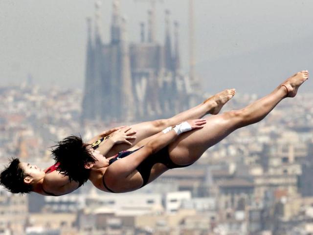 China's Chen Roulin, right, and Liu Huixia perform during a synchronized 10-meter platform diving training session ahead of the FINA Swimming World Championships in Barcelona, Spain. (AP Photo)