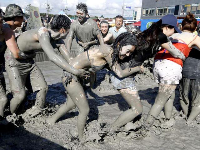 Tourists play in the mud during the Boryeong Mud Festival at Daecheon beach in Boryeong, about 190 km (118 miles) southwest of Seoul. Reuters