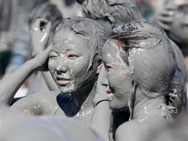 Tourists play in the mud during the Boryeong Mud Festival at Daecheon beach in Boryeong, about 190 km (118 miles) southwest of Seoul. Reuters