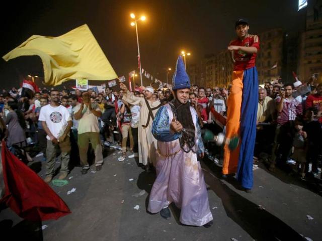Opponents of ousted President Mohammed Morsi act as clowns as they dance during a rally at Tahrir square, in Cairo, Egypt. (AP Photo)