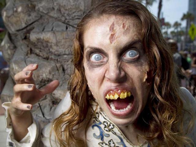 Dressed as a Deadite, Lola Kelly poses for a photo while roaming the area, at Comic Con, in San Diego. (AP Photo)