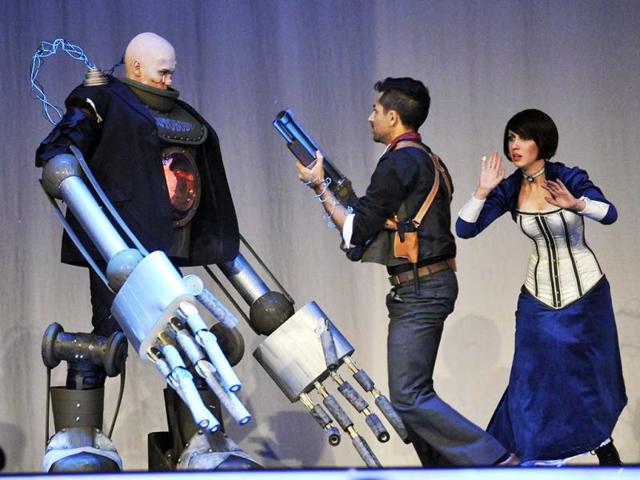 Attendees show off their Booker, Elizabeth and the Handyman costumes in a skit at the 2013 Comic-Con International Masquerade. (AP Photo)