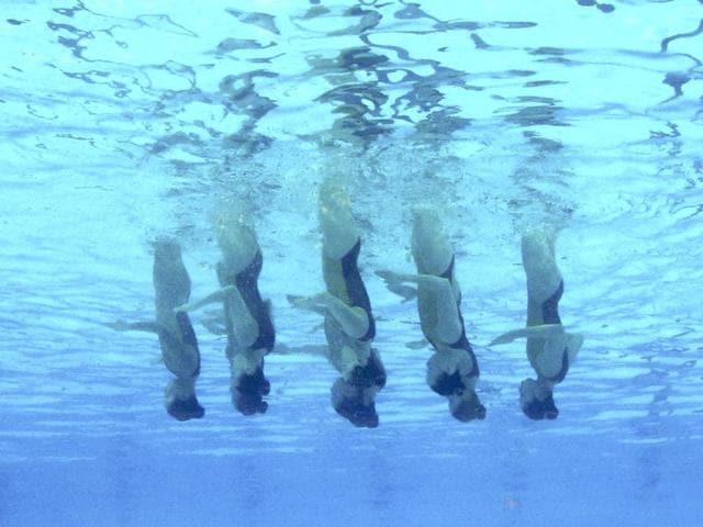 Japan's team are seen underwater as they perform in the synchronised swimming free combination routine preliminaries during the World Swimming Championships at the Sant Jordi arena in Barcelona. (Reuters)