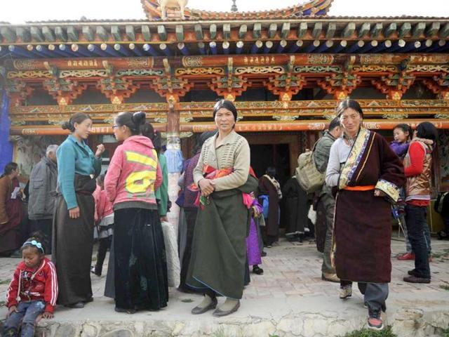 Tibetan women stand outside a monastery in Tianjun county, Qinghai province. REUTERS