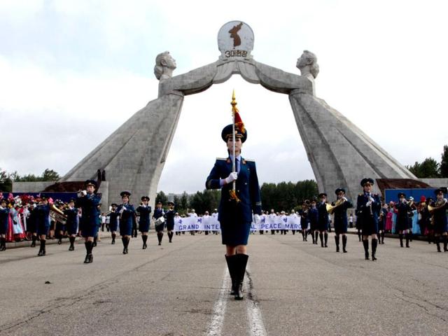 North Korean military band leads an international peace march at the Three Charters for National Reunification Memorial Tower in Pyongyang, North Korea. AP Photo