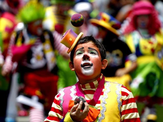 A clown juggles during a parade to inaugurate the 5th Annual Clowns' Convention in Guatemala City. Reuters photo