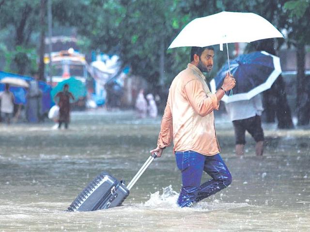 As water-logging slowed down traffic, many commuters chose to travel by foot. (Kunal Patil/HT)