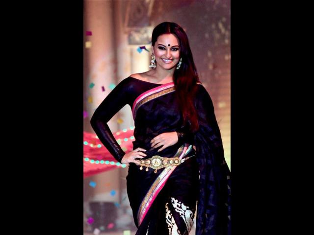 Sonakshi glams up the look with a boat neck blouse. (PTI Photo)