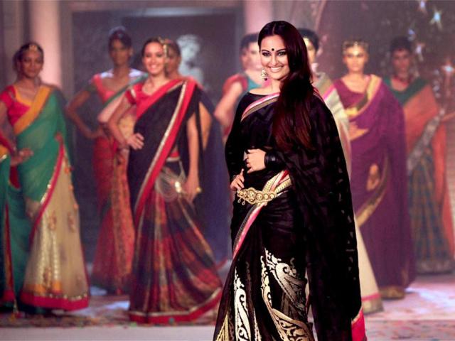 Bollywood actress Sonakshi Sinha, known for her ethnic style, pulls off this black sari with a lot of grace at a fashion show in Bengaluru. (PTI Photo)