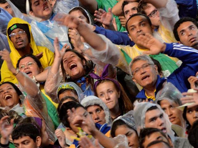 Pilgrims attend the World Youth Day inaugural Mass on Copacabana beach in Rio de Janeiro, Tuesday, July 23, 2013. As many as 1 million young people from around the world are expected in Rio for the Catholic youth event. Pope Francis arrived in Rio de Janeiro on Monday to begin a weeklong visit to participate in the WYD festival. (AP Photo)