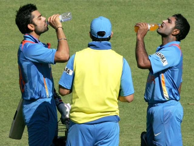 Virat Kohli and Ambabti Rayudu drink water during the first match of the five match ODI cricket series between India and hosts Zimbabwe at the Harare Sports Club . (AFP photo).