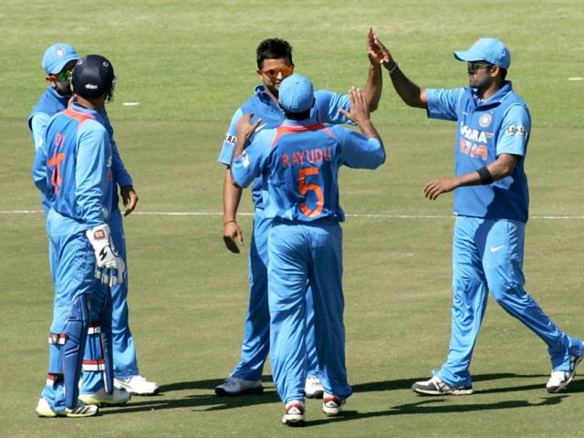 Suresh Raina is congratulated by teammates after getting a wicket during the first of the five ODI cricket series matches between India and hosts Zimbabwe at the Harare Sports Club . (AFP photo)