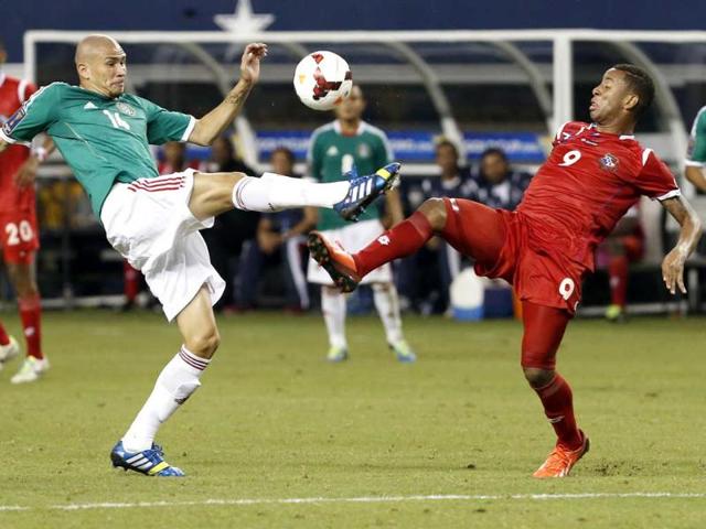 Mexico's Jorge Enriquez (14) and Panama's Gabriel Torres (9) battle for possession of the ball in the second half of the Gold Cup semifinals at Cowboys Stadium in Arlington, Texas. Panama won 2-1. (AP Photo)