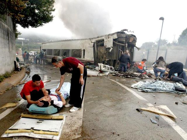Victims receive help after a train crashed near Santiago de Compostela, northwestern Spain. REUTERS