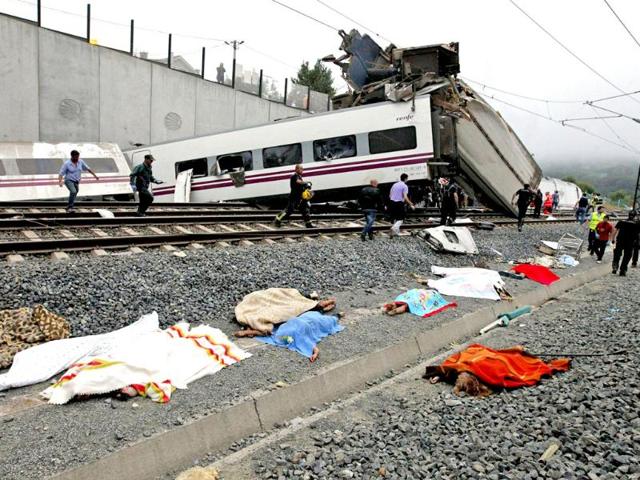 Bodies are covered with blankets as rescue workers continue to search for victims from a train crash near Santiago de Compostela, northwestern Spain. REUTERS
