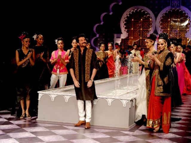Bollywood actor Anil Kapoor along with models presents creations by Raghavendra Rathore during the Indian Bridal Fashion Week in New Delhi. (AFP Photo)