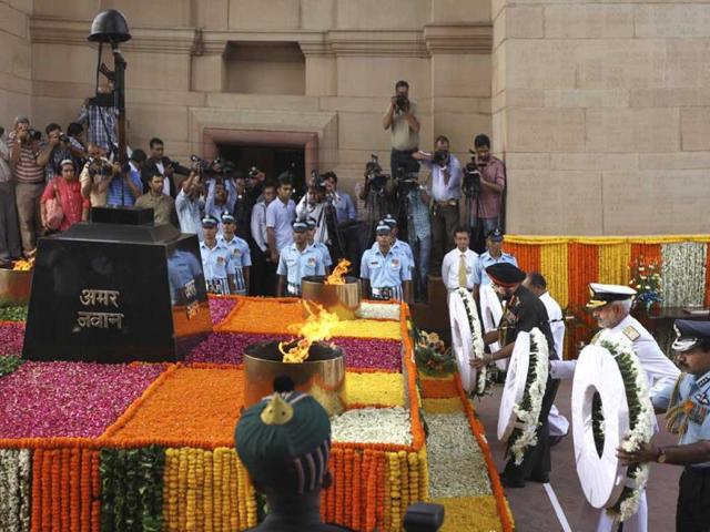 Indian army chief general Bikram Singh, third from right, Indian navy chief admiral Devendra Kumar Joshi, second from right, and Indian airforce chief air chief Marshal NAK Browne, right, pay tribute at India Gate war memorial on the 14th anniversary of India's victory in the Kargil War in New Delhi, India. (AP Photo)