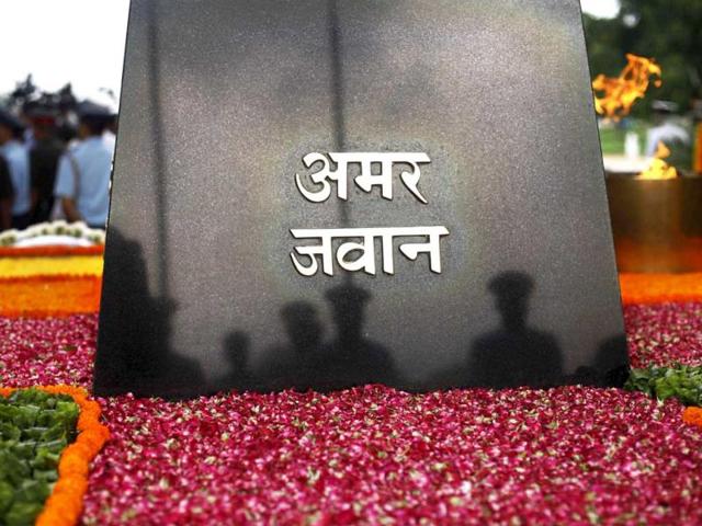 Shadows of soldiers are reflected on the memorial as they pay tribute at India Gate war memorial on the 14th anniversary of India's victory in the Kargil War in New Delhi. (AP Photo)