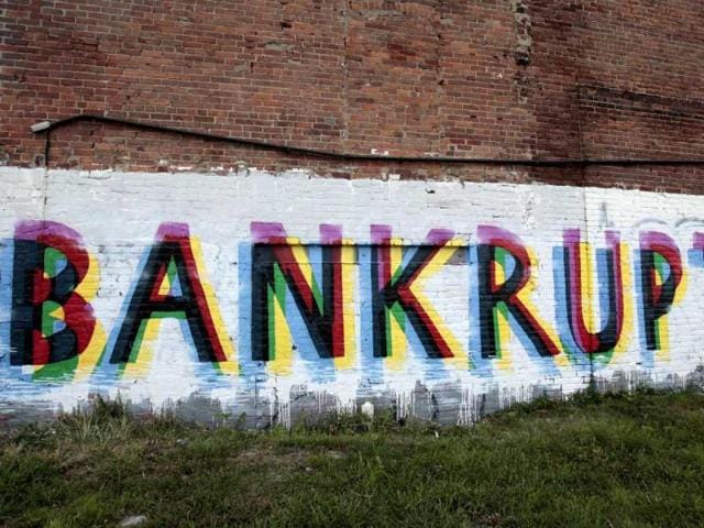 The word 'Bankruptcy' is seen painted on the side of a vacant building by street artists as a statement on the financial affairs of the city on Grand River Avenue in Detroit, Michigan. (Reuters)