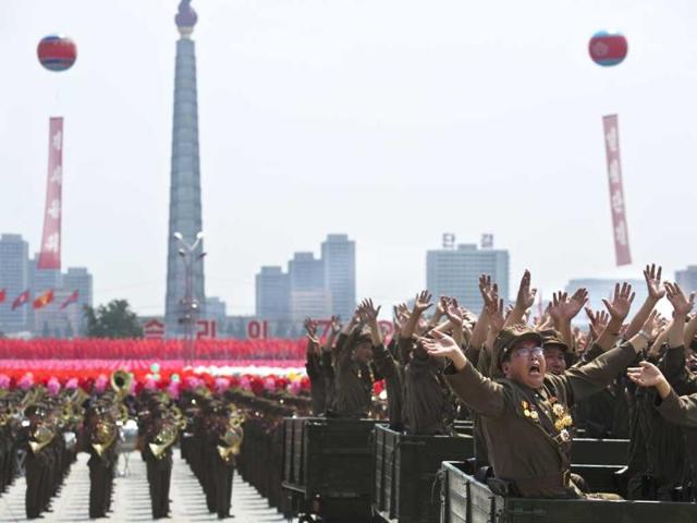 North Korean military veterans wave to their leader Kim Jong Un during the 60th anniversary celebrations of the Korean War. (AP Photo)