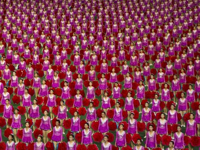 North Korean girls stand at attention at the May Day Stadium in Pyongyang, on the eve of the 60th anniversary of the Korean War armistice. (AP Photo)