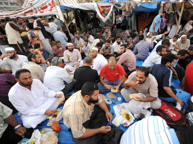 Egyptian supporters of deposed president Mohamed Morsi break their fasting during Ramzan in Cairo as they continue to hold a sit-in outside Rabaa al-Adawiya mosque. (AFP photo)