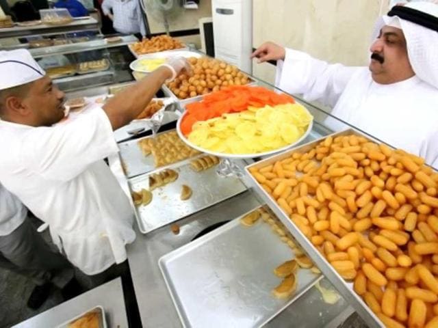 A customer orders sweets at a pastry shop during the Muslim fasting month of Ramzan in Kuwait. (AFP photo)