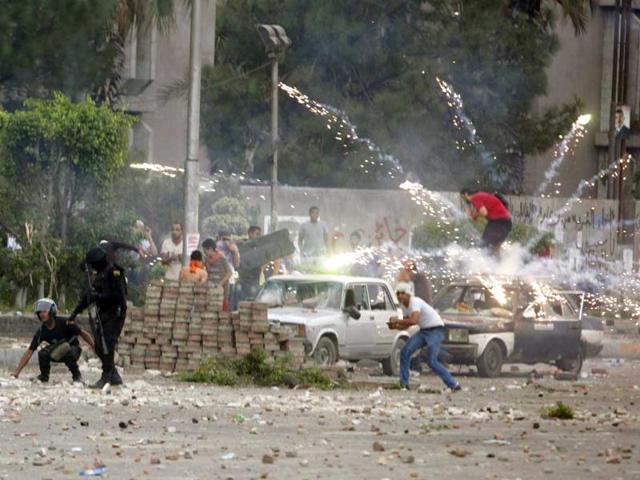 Fireworks are set off near police and anti-Mursi protesters by supporters of deposed Egyptian President Mohamed Mursi during clashes in Nasr city area, east of Cairo July 27, 2013. REUTERS