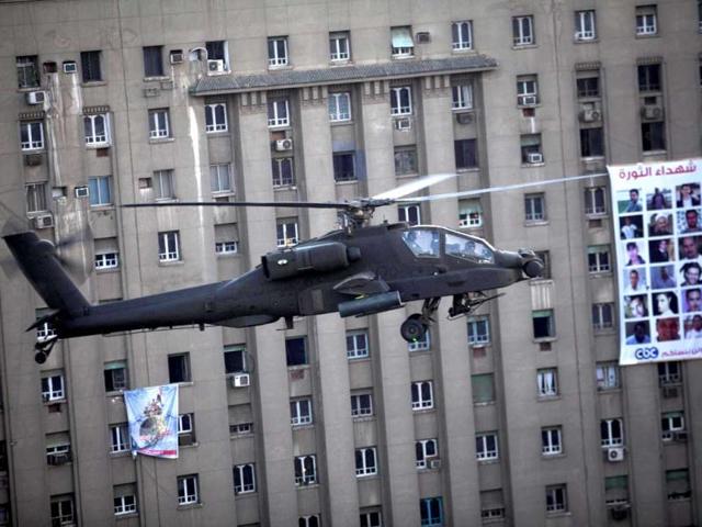 An Egyptian Army helicopter flies over thousands of supporters of Egypt's top military officer, Gen. Abdel-Fatah el-Sissi during a rally in Tahrir Square in Cairo, Egypt, Friday, July 26, 2013. (AP Photo)