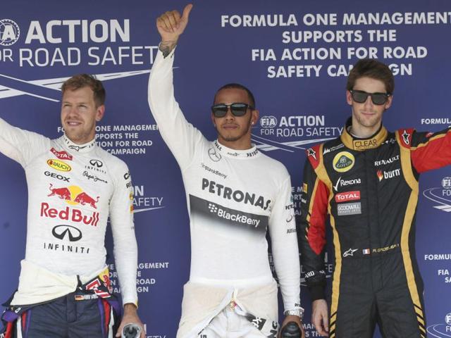 Mercedes-driver-Lewis-Hamilton-of-Britain-C-after-taking-pole-position-with-Red-Bull-driver-Sebastian-Vettel-of-Germany-L-and-Lotus-driver-Romain-Grosjean-of-France-R-at-the-Hungaroring-racetrack-near-Budapest-AP-Photo Mercedes-driver-Lewis-Hamilton-of-Britain-C-after-taking-pole-position-with-Red-Bull-driver-Sebastian-Vettel-of-Germany-L-and-Lotus-driver-Romain-Grosjean-of-France-R-at-the-Hungaroring-racetrack-near-Budapest-AP-Photo