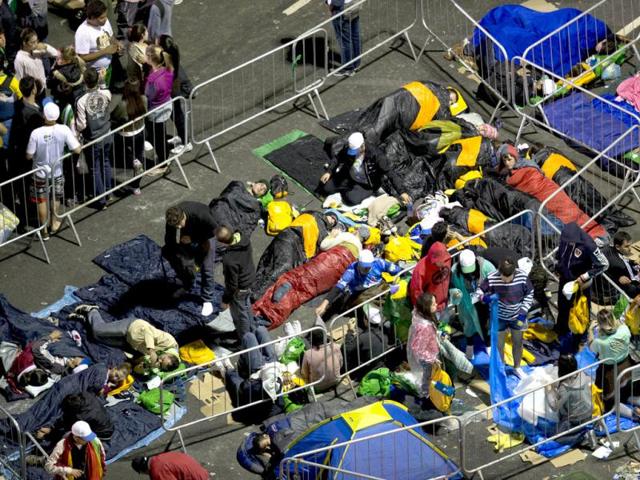 Pilgrims prepare to sleep on the street during a vigil part of the World Youth Day celebrations in Copacabana beach in Rio de Janeiro, Brazil. (AP Photo)
