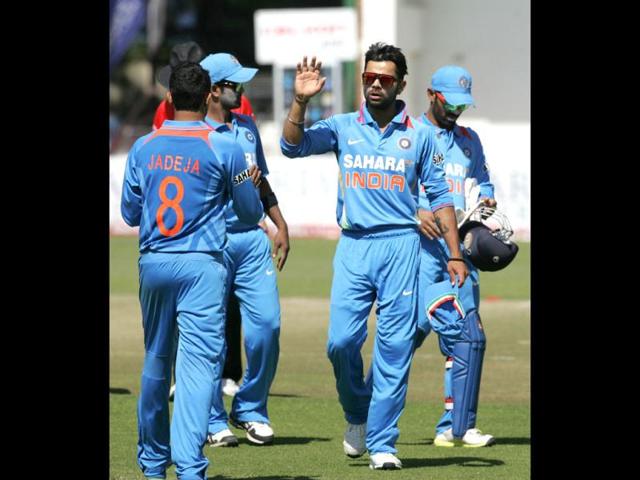 India captain Virat Kohli leads his team off the pitch after restricting the Zimbabwe innings to less than 183 during the third ODI at the Harare Sports Club. (AFP Photo)