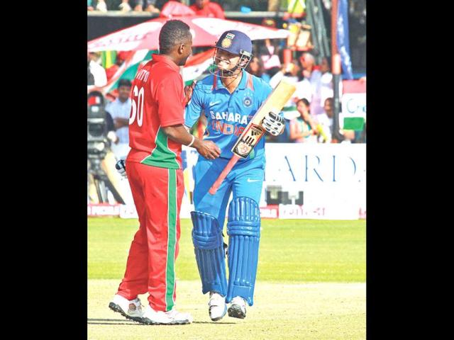Indian captain Virati Kohli (R) and Zimbabwean bowler Brian Vitori chat during their third ODI, in Harare. (AP Photo)