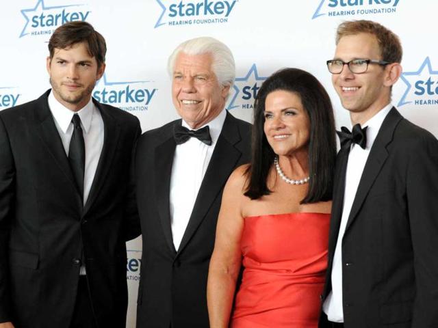 From left, Ashton Kutcher, Bill Austin, Tani Austin and Michael Kutcher are seen walking the red carpet at the Starkey Foundation's 2013 "So the World May Hear" Awards Gala in St. Paul, Minn. (AP Photo)