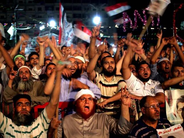 Supporters of Egypt's ousted President Mohammed Morsi chant slogans at Nasr City, where protesters have installed a camp and hold daily rallies, in Cairo, Egypt. (AP Photo)