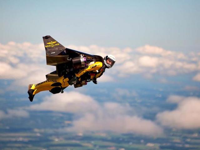 Swiss adventurer Yves Rossy, also known as "Jetman," flies in his carbon-Kevlar jetwing with four engines during an event for reporters. (AP Photo)