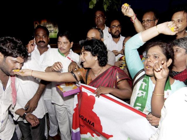 Telangana supporters celebrate outside AICC headquarters in New Delhi after Congress Working Committee endorsed a decision to create separate Telangana state. (PTI Photo)
