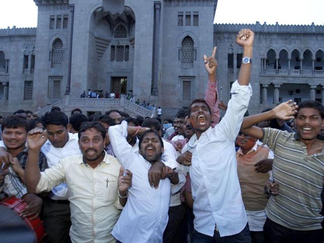 Students of Osmania University celebrate after UPA endorsed the creation of a new state Telangana in Hyderabad. (AP Photo)
