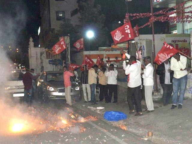 CPI workers celebrate at Himayat nagar in Hyderabad, after Congress Working Committee endorsed a decision to create separate Telangana state. (PTI Photo)