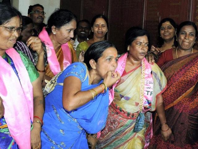 TRS party workers celebrate in Hyderabad after Congress Working Committee endorsed a decision to create separate Telangana state. (PTI photo)