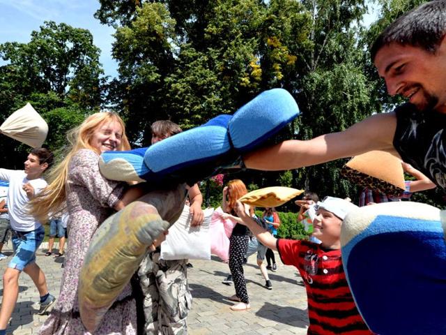 Young people fight with pillows during a happening called Battle With Pillows in Kiev. Hundreds of young Ukrainians entertain themselves organizing events via social networks. AFP photo